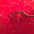 Spoon full red jello Royalty Free Stock Photo
