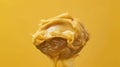 A spoon full of something that is being drizzled on a yellow background, AI