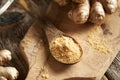 A spoon of ginger root powder, with whole fresh root Royalty Free Stock Photo