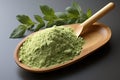 Spoon with green matcha tea powder on wooden utensil Royalty Free Stock Photo