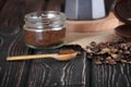 Spoon ground coffee with coffee beans