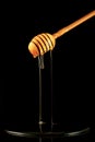 Spoon of honey. On a black background. Dripping fresh honey. Royalty Free Stock Photo