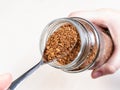 Spoon with instant coffee over glass jar Royalty Free Stock Photo