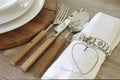 Spoon knife fork and dishware over a rustic table Royalty Free Stock Photo