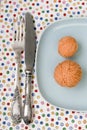 Spoon and knife lying on bright tablecloth