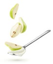 Spoon with natural yogurt and flying slices of pear fruit isolated on white