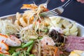 Spoon the Papaya salad with eggs and vegetables on a tray