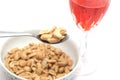Spoon of peanuts and glass of drink isolated on a white background Royalty Free Stock Photo