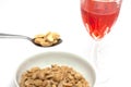 Spoon of peanuts and glass of drink isolated on a white background Royalty Free Stock Photo