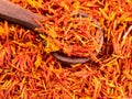 Spoon on pile of dried safflower petals closeup