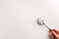 Spoon with pills in the hand, isolated on white background