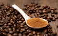 spoon with powder and coffee beans on old wooden spoon Royalty Free Stock Photo