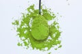 A spoon with powdered matcha green tea, isolated on light background, copy space, top view Royalty Free Stock Photo