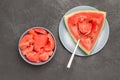 Spoon in pulp of ripe watermelon. Pieces of watermelon in gray bowl Royalty Free Stock Photo