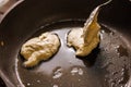 spoon puts semi-liquid dough into a preheated pan covered with vegetable oil Royalty Free Stock Photo