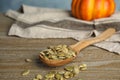 Spoon of raw peeled pumpkin seeds. Space for text Royalty Free Stock Photo