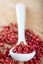 A spoon with red pepper corns Royalty Free Stock Photo