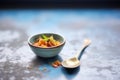 spoon resting in an empty bowl with granola crumbs