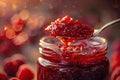 Raspberry jam. Spoon scooping homemade raspberry jam from a glass jar surrounded by fresh raspberries Royalty Free Stock Photo