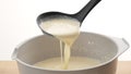 Spoon scoops pancake batter. Royalty Free Stock Photo