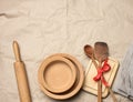 Spoon and spatula tied with red ribbon on a brown paper background and wooden rolling pin Royalty Free Stock Photo