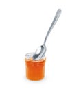 Spoon with tasty apricot jam on white background Royalty Free Stock Photo