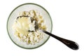 Spoon in glass bowl with cottage cheese poured condensed milk isolated on white. Top view Royalty Free Stock Photo