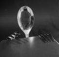 A spoon and two forks at the table are being prepared for a meal. Creative still life concept. Black and white design. Royalty Free Stock Photo