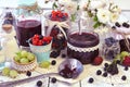 Spoon and vintage glass jars with jam, fresh berry on the table Royalty Free Stock Photo