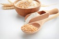 Spoon with wheat grains and scoop with flour on white background Royalty Free Stock Photo