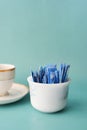 Sugar Substitute sweetener packet and tea cup on white background Royalty Free Stock Photo