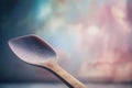 a spoon with a wooden handle on a table with a blurry background