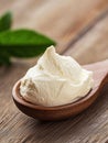A spoonful of cream cheese sits on a wooden table Royalty Free Stock Photo