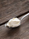 Spoonful of cream cheese on a wooden table Royalty Free Stock Photo