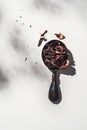 Spoonful of dried hibiscus on white background