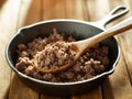 Spoonful of freshly cooked ground beef from iron skillet Royalty Free Stock Photo