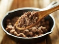 Spoonful of freshly cooked ground beef from iron skillet