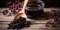 Spoonful of homemade elderberry syrup, set against a wooden backdrop, emphasizing the use of natures ingredients for