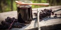 Spoonful of homemade elderberry syrup, set against a wooden backdrop, emphasizing the use of natures ingredients for