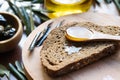 Spoonful of Olive Oil on Brown Bread