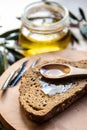 Spoonful of Olive Oil on Brown Bread