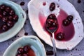 Spoonful of sour Morello cherries on vintage ceramic platter