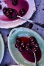 Spoonful of sour Morello cherries on vintage ceramic platter