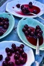 Spoonful of sour Morello cherries on vintage ceramic platter