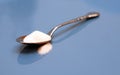 Spoonful of sugar on blue background Royalty Free Stock Photo