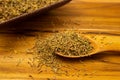 A spoonful of thyme on the wooden table.
