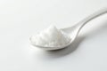 Spoonful of white sugar against white backdrop, sprinkle, macro Royalty Free Stock Photo