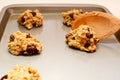 Spooning oatmeal raisin cookie dough onto a baking sheet