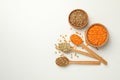 Spoons and bowls with different legumes on white background Royalty Free Stock Photo