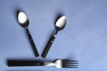 Spoons and fork on color background Royalty Free Stock Photo